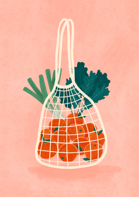 A net shopping bag filled with bright red oranges, green leafy vegetables, and leeks, set against a soft pink background.